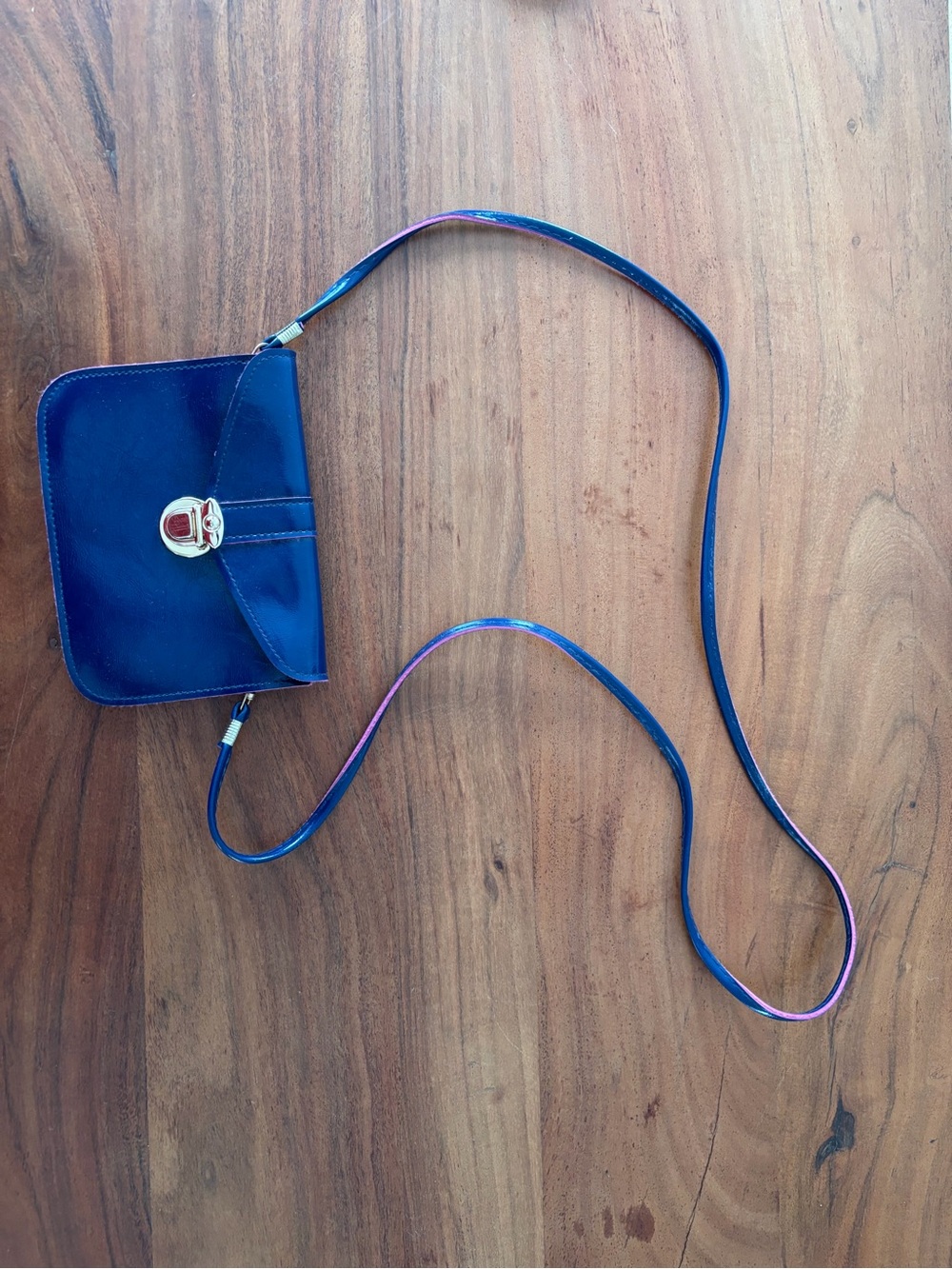Iridescent Blue Crossbody Bag with Turn-Lock Closure and pink lining